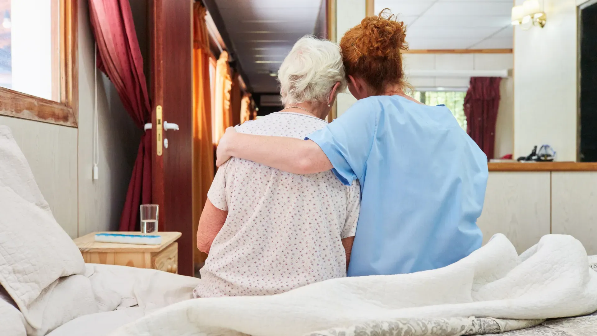 Healthcare worker hugging patient